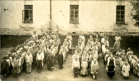 Kyminlinnan pakolaiskoulun ensimmäiset oppilaat opettajineen kesällä 1922. Opett. Maikki Gertsin joht Paavo [?] Hallikainen Nasti Prokkonen Toini Tuomela Tarja Mauranen-Kiirikki T. Tuomela ---kaksoiskappaleesta:--- Kyminlinna kesällä 1922 Vain naisopettajien nimet ovat tiedossa: vas. Maikki Gertzin, miesopettajasta seuraavana Nasti Gertzin ja Toini Tuomela. Oikealla Daria Mauranen. -Lapset ovat etupäässä Uhtuan, Vuokkiniemen ja Paanajärven seuduilta